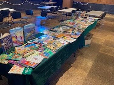 Table with children's books from the Library birthday party in July 2023